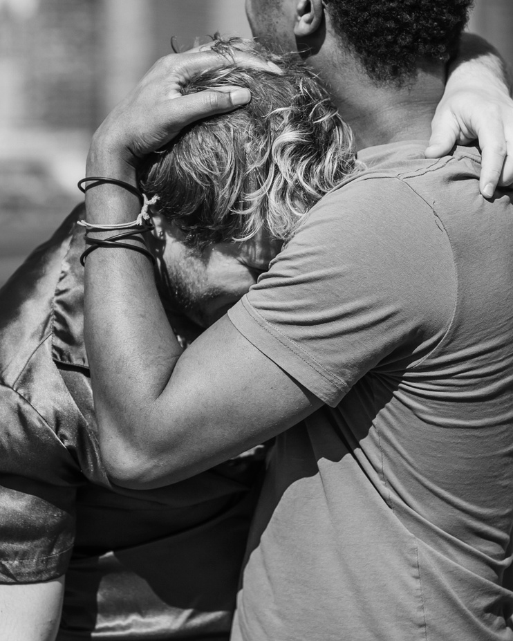 Grayscale Photo of Men Hugging